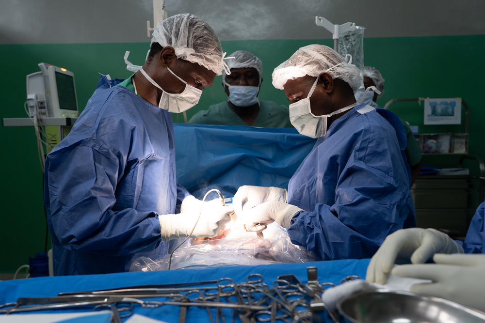 Des chirurgiens de l'hôpital général de référence de Rutshuru cautérisent une plaie chez un jeune homme blessé par balle. RDC, août 2025©Sam Bradpiece/MSF