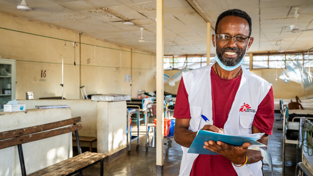 Member of the MSF nursing team checking some of the documentation of the patients at the male ward.