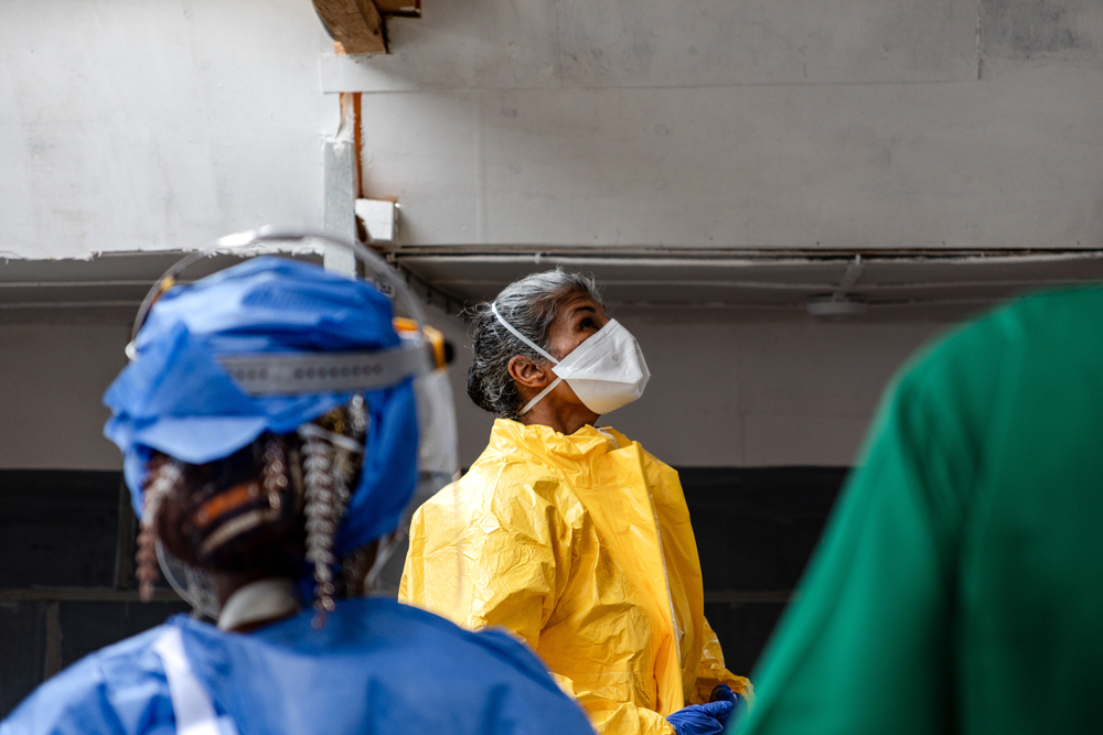 Dr Rupa Narra, pédiatre au CTE de Kitatumba, suit scrupuleusement les étapes du déshabillage, à sa sortie de consultations de patients pédiatriques suspects. Août 2026 ©Lucie Ringué/MSF